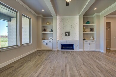 Living room with ceiling fan, crown molding, wood-