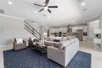 Spacious main living area is adorned with crown molding and open kitchen