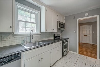 Goose neck faucet, stainless sink, newer countertops and backsplash