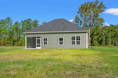 View of home's exterior with a sunroom and a yard