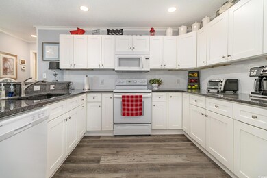 Kitchen featuring a sink, white appliances, crown 