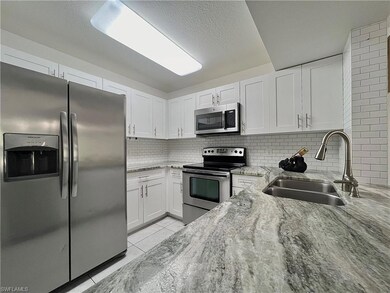 Kitchen featuring stainless steel appliances, whit