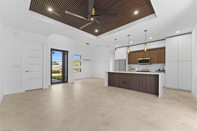 Kitchen featuring a tray ceiling, stainless steel 