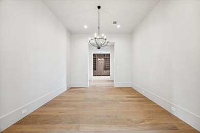 View from the dining room to the entry hall and study.  The ceiling heights on the first floor are 12' and 11' on the second floor.