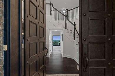 Entryway featuring stairway, dark wood finished f