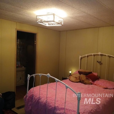 Bedroom featuring a decorative wall and a textured ceiling