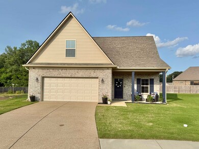 View of front facade with brick siding, driveway, a garage, and a shingled roof