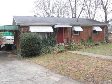 HAS CARPORT ON L SIDE AND SMALL COVERED PORCH.