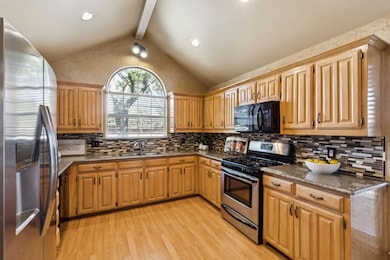 The room is ringed with upper and lower cabinets providing wonderful storage. Nice expanses of countertops give abundant room to work on culinary creations.