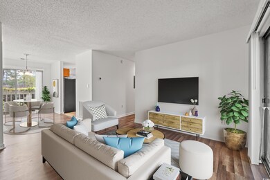 Living area with baseboards, a textured ceiling, w