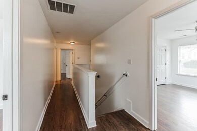 Corridor featuring dark hardwood / wood-style floo