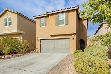 View of front of house featuring stucco siding, concrete driveway, a tile roof, and an attached garage