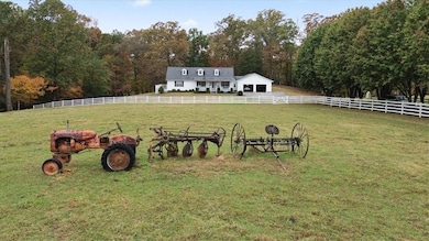 View of yard featuring a forest view, a view of countryside, and an outdoor structure