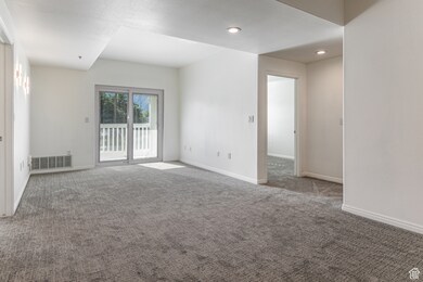 Spare room featuring carpet and recessed lighting