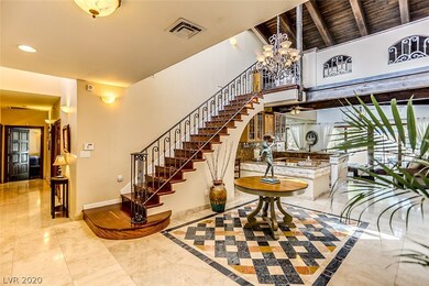 Enter into this grand foyer with travertine tile,