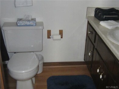 Master bath with laminate wood floors and shower/t
