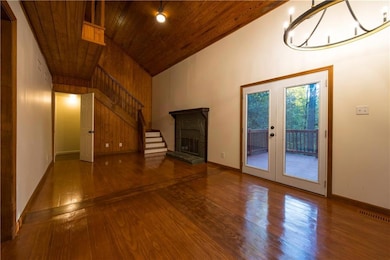 Living room featuring hardwood flooring, high vaul