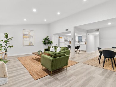 Living room with light hardwood / wood-style floor