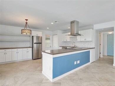 Kitchen featuring white cabinets, stainless steel 