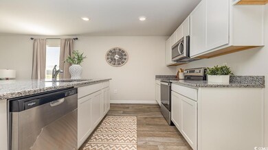 Kitchen with light stone countertops, appliances w