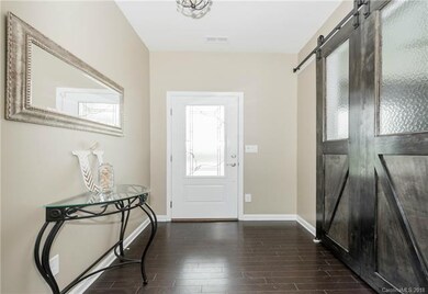 Stunning Foyer with Custom Barn Doors leading to y