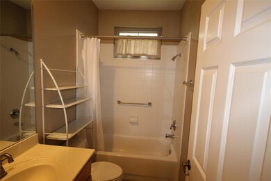 Bathroom with shower / bath combo and vanity