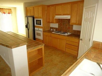 Attractive Tile Counters and Includes Refrigerator