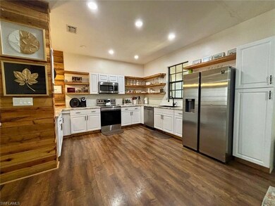 Kitchen with open shelves, visible vents, stainles