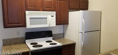 Kitchen featuring light countertops and white appl