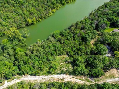 Drone / aerial view of a large body of water and a heavily wooded area