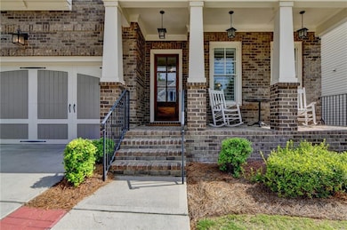 Entrance to property with brick siding and covered