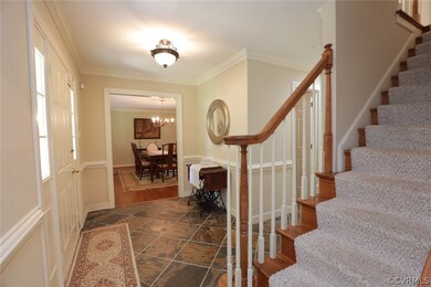 Entrance foyer with dark tile flooring, ornamental