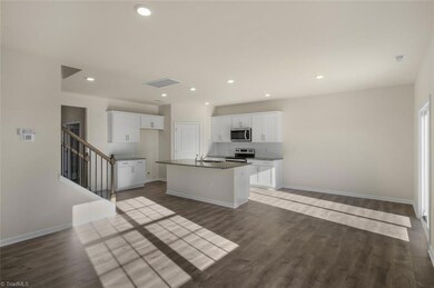 Open kitchen/dining/family room. Photo is representative