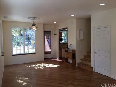 Open sunny living room includes a large under stai