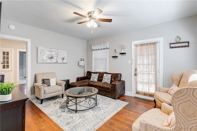 Living area featuring ceiling fan and wood finishe