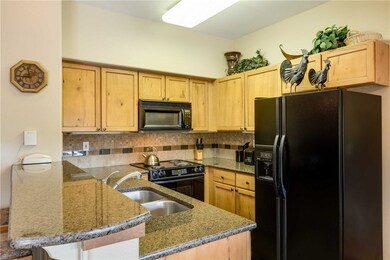 Efficient kitchen with slab granite counter tops.