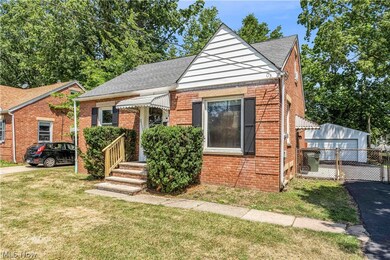 Bungalow-style house featuring a garage and a front lawn