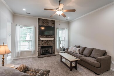 Vaulted 10-ft living room ceilings with floor to ceiling bricked gas fire place.