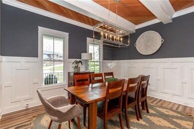 Casual custom dining room with wainscotting, beams