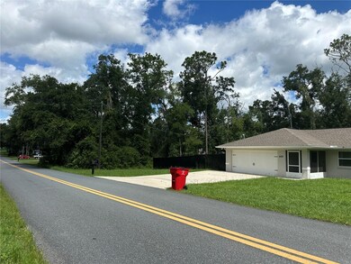 The home on the east side of the vacant lot.