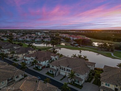 Aerial view at dusk featuring a water & golf cours