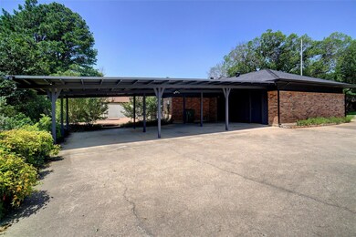 View of vehicle parking featuring a carport