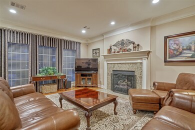 Family room features crown molding, cozy fireplace and a view of the backyard.