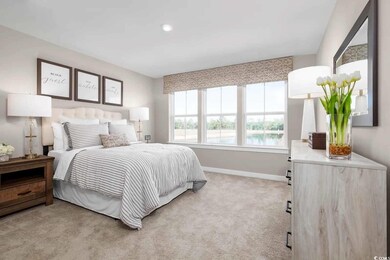 Carpeted bedroom featuring a water view
