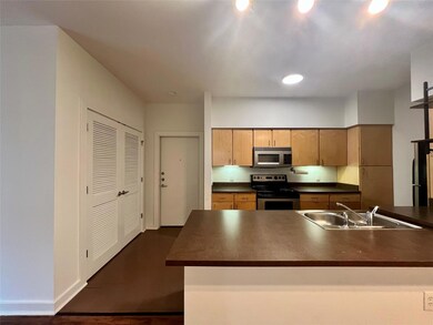 Kitchen with stainless steel appliances, dark cou