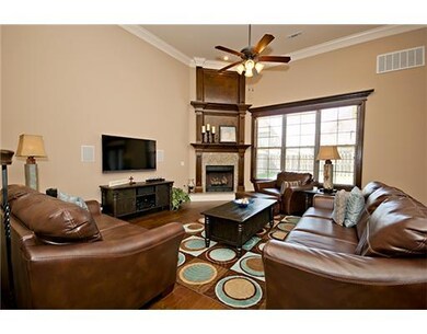 Living Room. Floor-to-ceiling fireplace, lots of natural light & crown molding!