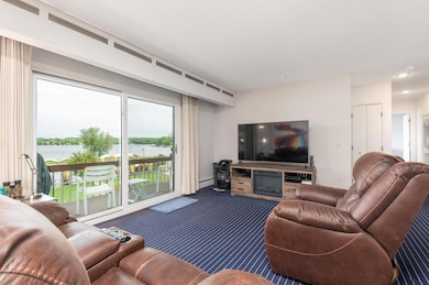 Entertain guests in the living room with a new 8 foot triple pane sliding door with outstanding lake views!