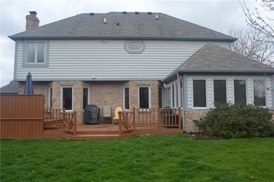 Rear elevation with 2-level deck and spectacular sunroom.