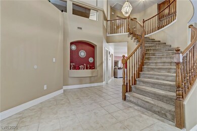 Entryway featuring tile patterned floors, stairs,