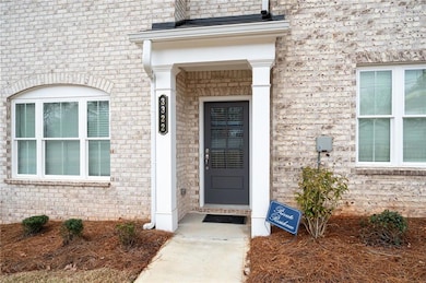 View of exterior entry featuring brick siding